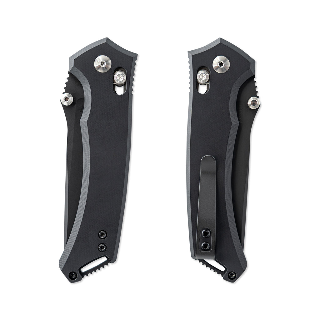Two black folding knives with metallic accents on a white background