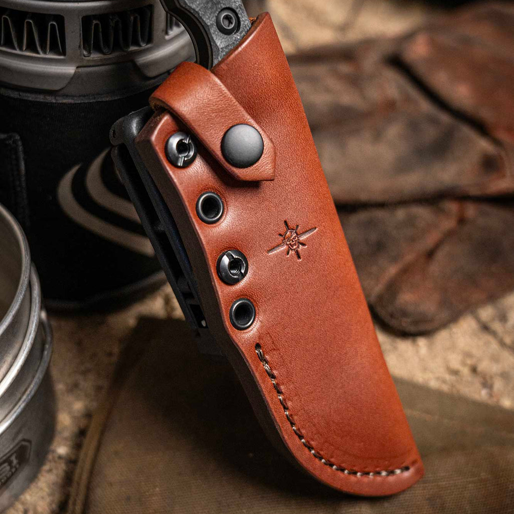 Brown leather sheath with a knife on a textured surface
